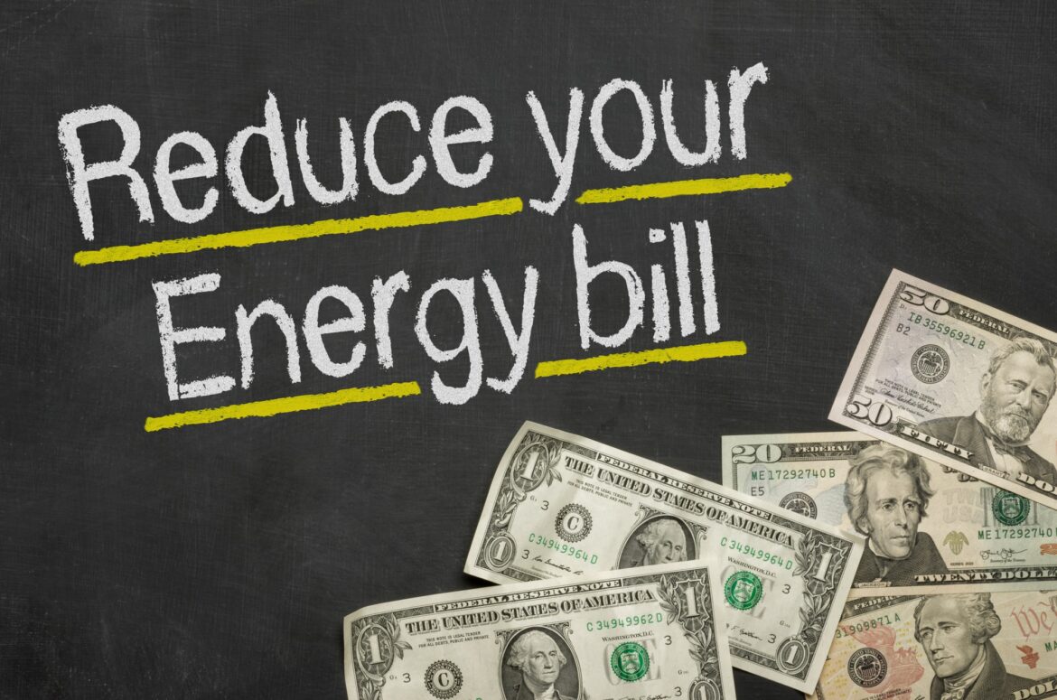 Text on blackboard with money — Reduce your energy bill